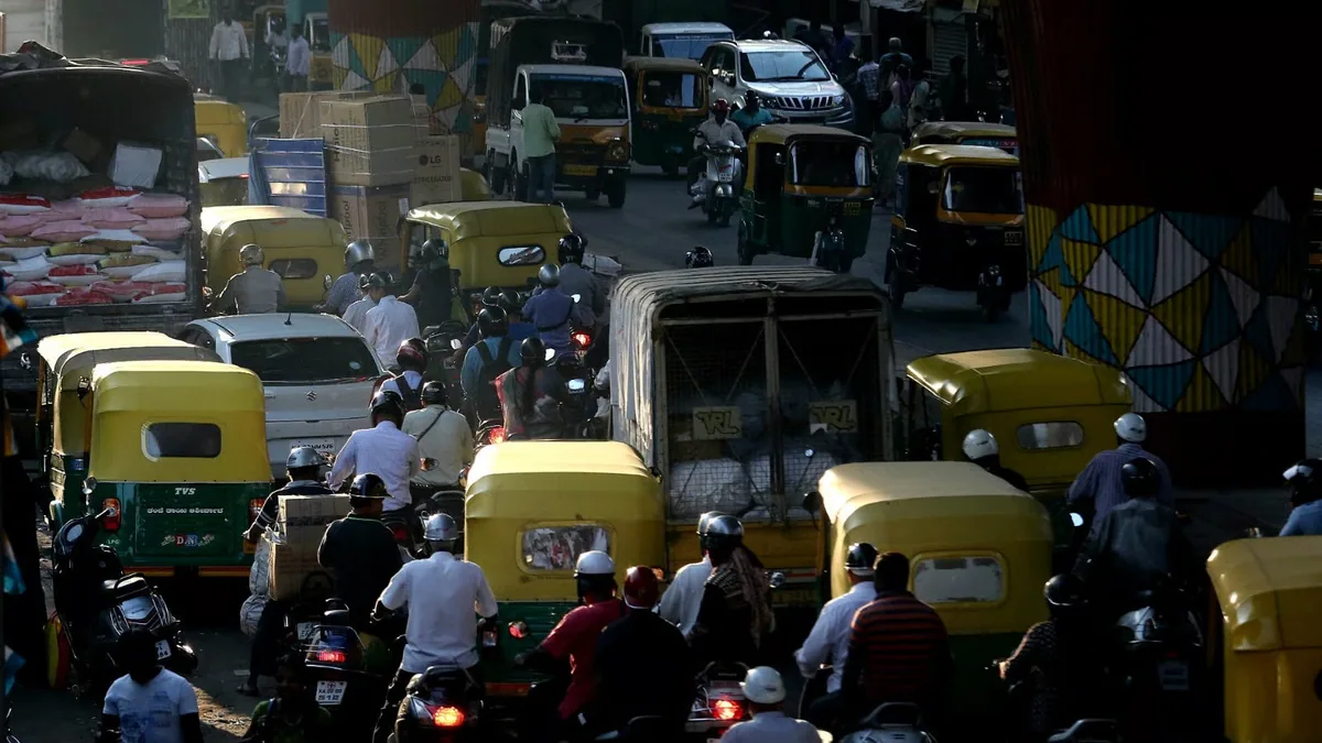 Two-wheelers, autos and a truck packed into traffic at Silk Board junction